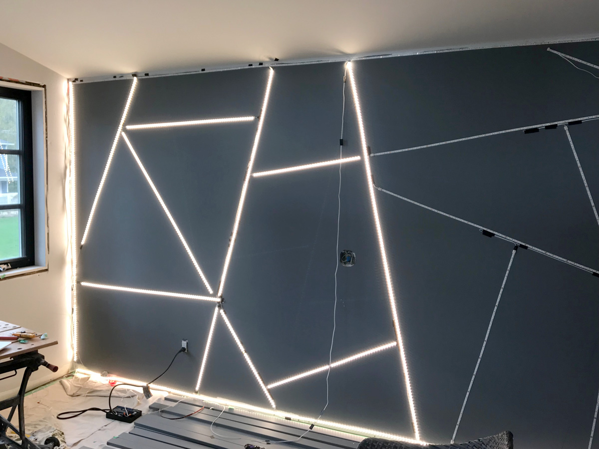 Geometric feature wall wired with LED tape lights & half lit