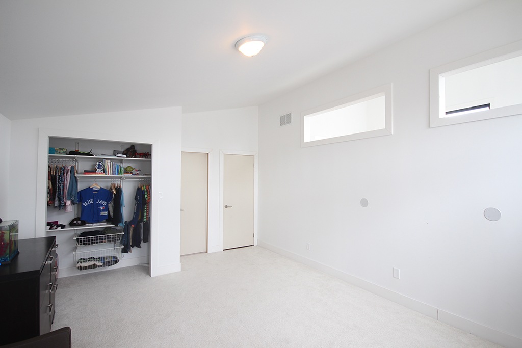 Boys bedroom before: blank walls & unpainted doors create and uninspiring space.
