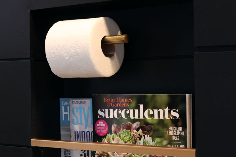 Magazines & toilet paper are inset into the wall in this stylish niche