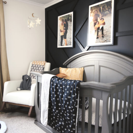 Geometric accents in the crib bedding play off the geometric feature wall